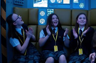 Three children celebrate while sat in the Escape Pod of the TetraStar Space Mission.